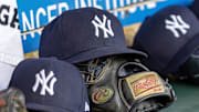 Apr 7, 2025; Detroit, Michigan, USA; New York Yankees baseball hats and gloves in the dugout out in the eighth inning against the Detroit Tigers at Comerica Park. Mandatory Credit: David Reginek-Imagn Images