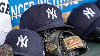 Apr 7, 2025; Detroit, Michigan, USA; New York Yankees baseball hats and gloves in the dugout out in the eighth inning against the Detroit Tigers at Comerica Park. Mandatory Credit: David Reginek-Imagn Images
