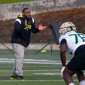 New offensive line coach A'lique Terry, center, runs a drill during the first practice of spring for Oregon football Thursday March 16, 2023