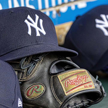 Apr 7, 2025; Detroit, Michigan, USA; New York Yankees baseball hats and gloves in the dugout out in the eighth inning against the Detroit Tigers at Comerica Park. Mandatory Credit: David Reginek-Imagn Images