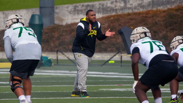 New offensive line coach A'lique Terry, center, runs a drill during the first practice of spring for Oregon football Thursday March 16, 2023