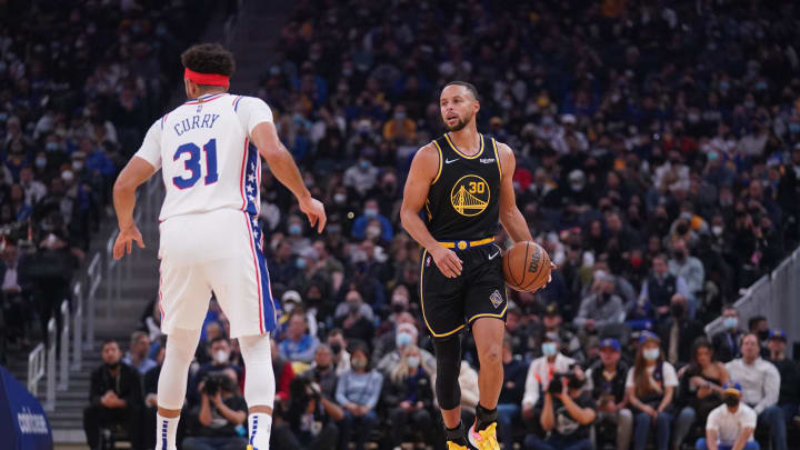 Nov 24, 2021; San Francisco, California, USA; Golden State Warriors guard Stephen Curry (30) dribbles the ball next to Philadelphia 76ers guard Seth Curry (31) in the first quarter at the Chase Center. Mandatory Credit: Cary Edmondson-USA TODAY Sports