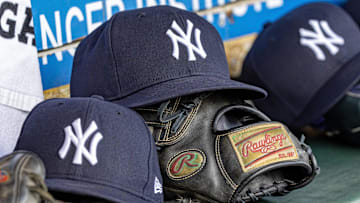Apr 7, 2025; Detroit, Michigan, USA; New York Yankees baseball hats and gloves in the dugout out in the eighth inning against the Detroit Tigers at Comerica Park. Mandatory Credit: David Reginek-Imagn Images