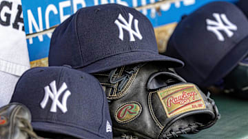 Apr 7, 2025; Detroit, Michigan, USA; New York Yankees baseball hats and gloves in the dugout out in the eighth inning against the Detroit Tigers at Comerica Park. Mandatory Credit: David Reginek-Imagn Images