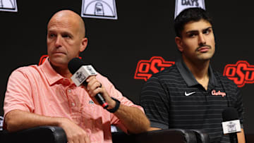 Oct 22, 2025; Kansas City, MO, USA; Oklahoma State head coach Steve Lutz (left) and Parsa Fallah speak to media during Big 12  Menís Basketball media day at T-Mobile Center. Mandatory Credit: Sophia Scheller-Imagn Images