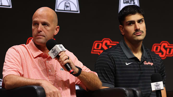 Oct 22, 2025; Kansas City, MO, USA; Oklahoma State head coach Steve Lutz (left) and Parsa Fallah speak to media during Big 12  Menís Basketball media day at T-Mobile Center. Mandatory Credit: Sophia Scheller-Imagn Images