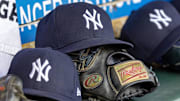 New York Yankees baseball hats and gloves in the dugout out in the eighth inning against the Detroit Tigers.