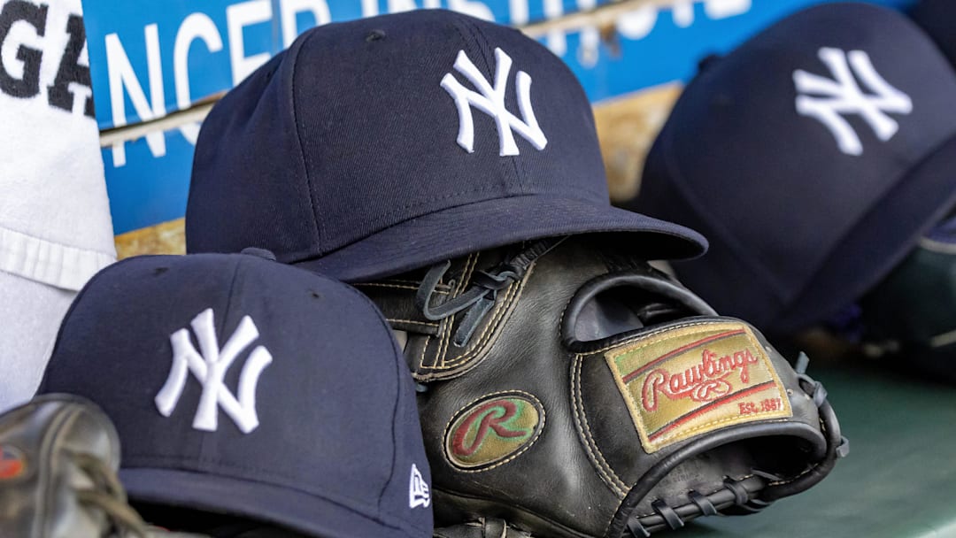 Apr 7, 2025; Detroit, Michigan, USA; New York Yankees baseball hats and gloves in the dugout out in the eighth inning against the Detroit Tigers at Comerica Park. Mandatory Credit: David Reginek-Imagn Images