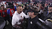 Texas Longhorns head coach Steve Sarkisian and Georgia Bulldogs head coach Kirby Smart interact after a game at Sanford Stadium.