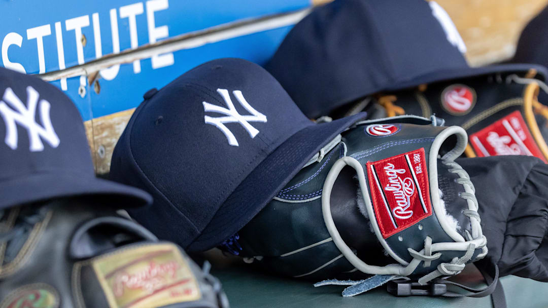 Apr 7, 2025; Detroit, Michigan, USA; New York Yankees baseball hats and gloves in the dugout out in the eighth inning against the Detroit Tigers at Comerica Park. Mandatory Credit: David Reginek-Imagn Images