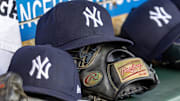 Apr 7, 2025; Detroit, Michigan, USA; New York Yankees baseball hats and gloves in the dugout out in the eighth inning against the Detroit Tigers at Comerica Park. Mandatory Credit: David Reginek-Imagn Images