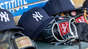 Apr 7, 2025; Detroit, Michigan, USA; New York Yankees baseball hats and gloves in the dugout out in the eighth inning against the Detroit Tigers at Comerica Park.