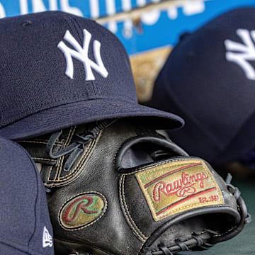 Apr 7, 2025; Detroit, Michigan, USA; New York Yankees baseball hats and gloves in the dugout out in the eighth inning against the Detroit Tigers at Comerica Park. Mandatory Credit: David Reginek-Imagn Images