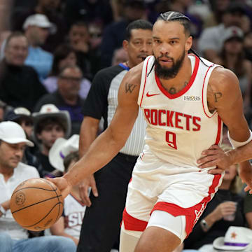 Mar 30, 2025; Phoenix, Arizona, USA; Houston Rockets forward Dillon Brooks (9) drives past Phoenix Suns guard Devin Booker (1) in the first half at Footprint Center. Mandatory Credit: Rick Scuteri-Imagn Images