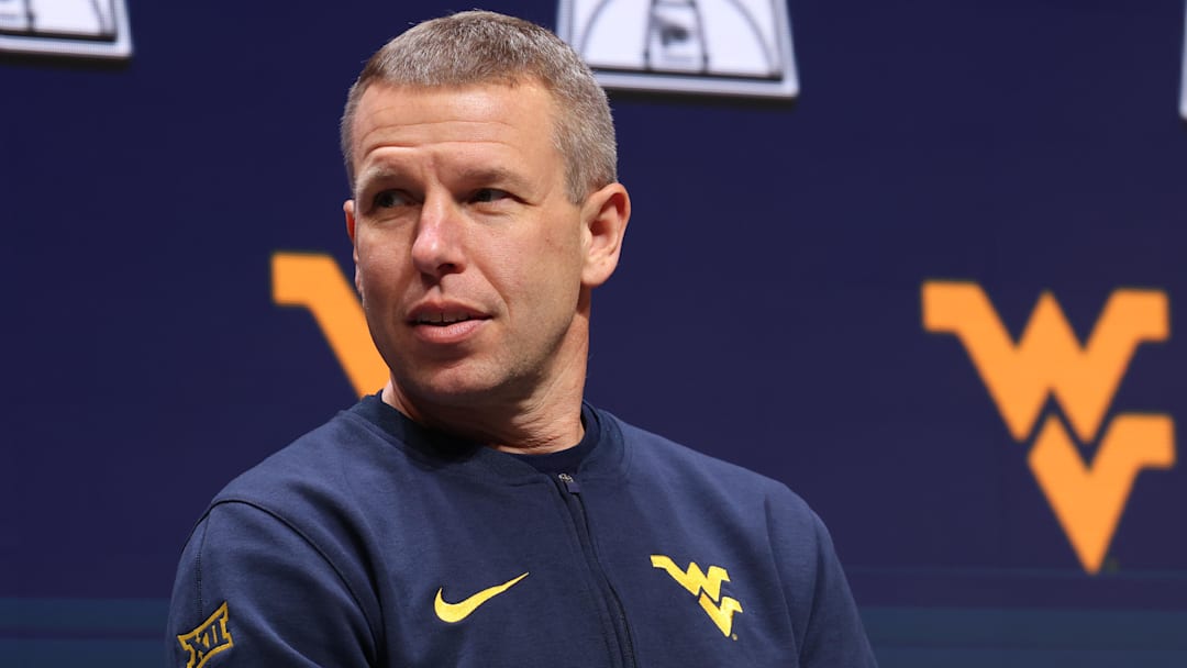 Oct 22, 2025; Kansas City, MO, USA; West Virginia head coach Ross Hodge speaks to media during Big 12 Menís Basketball media day at T-Mobile Center. Mandatory Credit: Sophia Scheller-Imagn Images Oct 22, 2025; Kansas City, MO, USA; West Virginia head coach Ross Hodge speaks to media during Big 12 Menís Basketball media day at T-Mobile Center. Mandatory Credit: Sophia Scheller-Imagn Images