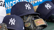 Apr 7, 2025; Detroit, Michigan, USA; New York Yankees baseball hats and gloves in the dugout out in the eighth inning against the Detroit Tigers at Comerica Park. Mandatory Credit: David Reginek-Imagn Images