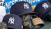 Apr 7, 2025; Detroit, Michigan, USA; New York Yankees baseball hats and gloves in the dugout out in the eighth inning against the Detroit Tigers at Comerica Park. Mandatory Credit: David Reginek-Imagn Images