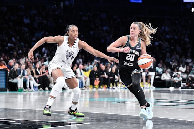 New York Liberty guard Sabrina Ionescu drives to the basket while defended by Golden State Valkyries forward Kayla Thornton.