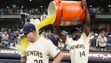 Jul 29, 2025; Milwaukee, Wisconsin, USA; Milwaukee Brewers shortstop Andruw Monasterio (14) dumps Gatorade over Milwaukee Brewers first base Andrew Vaughn (28) head after the game in which Milwaukee  Andrew Vaughn (28) hit a grand slam against the Chicago Cubs at American Family Field. Mandatory Credit: Michael McLoone-Imagn Images