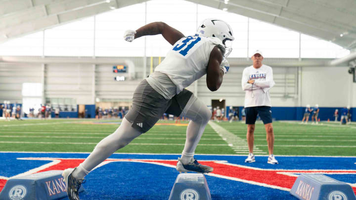 Kansas freshman defensive end Dakyus Brinkley (91) works through a drill during an indoor practice Wednesday, July 31