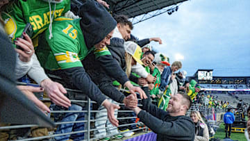 Oregon head coach Dan Lanning celebrates with fans after the Ducks dumped the Dawgs in Seattle.