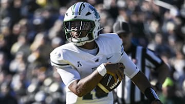 Nov 16, 2024; Annapolis, Maryland, USA;  Tulane Green Wave quarterback Darian Mensah (10) scores a touchdown during the first half against the Navy Midshipmen at Navy-Marine Corps Memorial Stadium. Mandatory Credit: Tommy Gilligan-Imagn Images