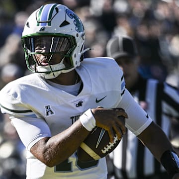 Nov 16, 2024; Annapolis, Maryland, USA;  Tulane Green Wave quarterback Darian Mensah (10) scores a touchdown during the first half against the Navy Midshipmen at Navy-Marine Corps Memorial Stadium. Mandatory Credit: Tommy Gilligan-Imagn Images