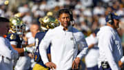 Oct 11, 2025; South Bend, Indiana, USA; Notre Dame Fighting Irish head coach Marcus Freeman looks to the scoreboard against the NC State Wolfpack during the first half at Notre Dame Stadium. 