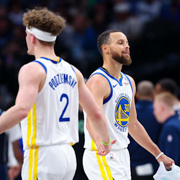 Apr 5, 2024; Dallas, Texas, USA;  Golden State Warriors guard Stephen Curry (30) reacts with Golden State Warriors guard Brandin Podziemski (2) after losing his shoe during the first half against the Dallas Mavericks at American Airlines Center. Mandatory Credit: Kevin Jairaj-Imagn Images