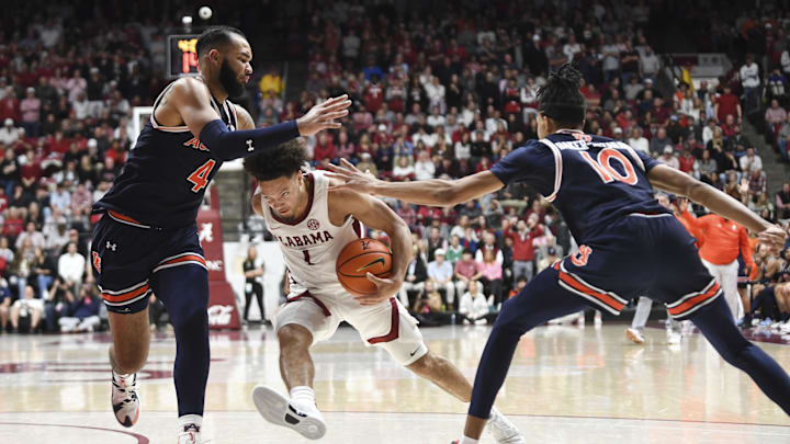 Jan 24, 2024; Tuscaloosa, Alabama, USA; Auburn Tigers center Johni Broome (4) and forward Chad Baker-Mazara (10) defend as Alabama Crimson Tide guard Mark Sears (1) attempts to drive into the lane at Coleman Coliseum. Mandatory Credit: Gary Cosby Jr.-Imagn Images Jan 24, 2024; Tuscaloosa, Alabama, USA; Auburn Tigers center Johni Broome (4) and forward Chad Baker-Mazara (10) defend as Alabama Crimson Tide guard Mark Sears (1) attempts to drive into the lane at Coleman Coliseum. Mandatory Credit: Gary Cosby Jr.-Imagn Images
