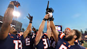 Oct 12, 2024; Champaign, Illinois, USA;  Fighting Illinois players celebrate with the Purdue Cannon in a 50-49 win against the Purdue Boilermakers at Memorial Stadium. Mandatory Credit: Ron Johnson-Imagn Images