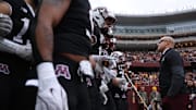 Nov 1, 2025; Minneapolis, Minnesota, USA; Minnesota Golden Gophers head coach P.J. Fleck leads his team onto the field before the game against the Michigan State Spartans at Huntington Bank Stadium. Mandatory Credit: Matt Krohn-Imagn Images