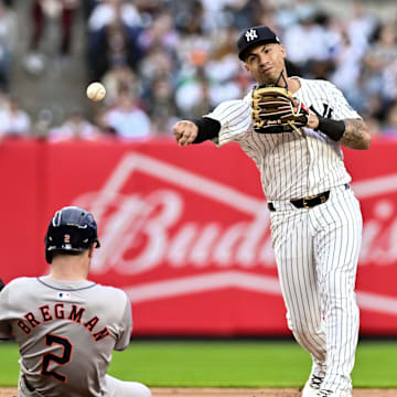 May 9, 2024; Bronx, New York, USA; New York Yankees second baseman Gleyber Torres (25) gets a force out at second base on Houston Astros third baseman Alex Bregman (2) and throws to first base to complete a double play during the sixth inning at Yankee Stadium.