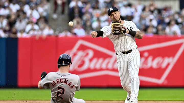 May 9, 2024; Bronx, New York, USA; New York Yankees second baseman Gleyber Torres (25) gets a force out at second base on Houston Astros third baseman Alex Bregman (2) and throws to first base to complete a double play during the sixth inning at Yankee Stadium.