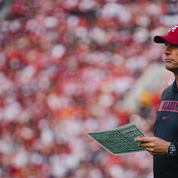 Sep 7, 2024; Tuscaloosa, Alabama, USA;  Alabama Crimson Tide head coach Kalen DeBoer reviews a checklist during a timeout in the first quarter at Bryant-Denny Stadium. Mandatory Credit: William McLelland-Imagn Images