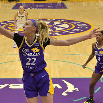 May 24, 2024; Los Angeles, California, USA;  Los Angeles Sparks forward Cameron Brink (22) blocks a shot by Indiana Fever forward Aliyah Boston (7)