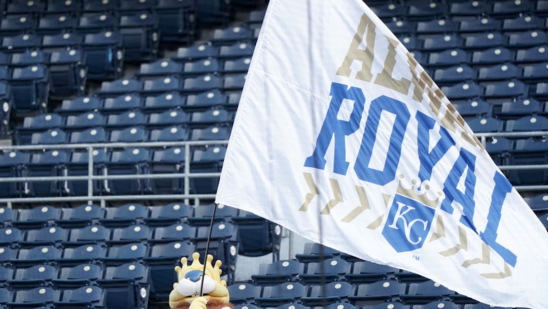 Aug 6, 2020; Kansas City, Missouri, USA; The Kansas City Royals mascot Sluggerrr waves an Always Royal flag in empty stands before the game against the Chicago Cubs at Kauffman Stadium. Mandatory Credit: Denny Medley-Imagn Images