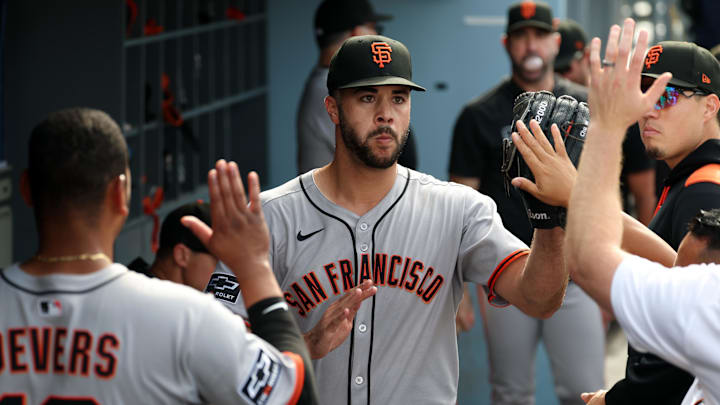 Sep 21, 2025; Los Angeles, California, USA;  San Francisco Giants relief pitcher Joey Lucchesi (middle) is greeted in the dugout after being relieved from the game during the ninth inning against the Los Angeles Dodgers at Dodger Stadium. Mandatory Credit: Kiyoshi Mio-Imagn Images