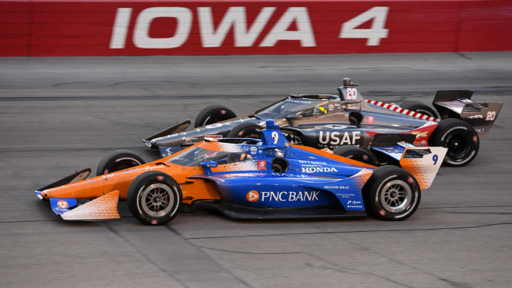 Jul 18, 2020; Newton, Iowa, USA; Indy Series driver Scott Dixon (9) and driver Ed Carpenter (20) compete during the Iowa Indycar 250 at Iowa Speedway. Mandatory Credit: Mike Dinovo-USA TODAY Sports