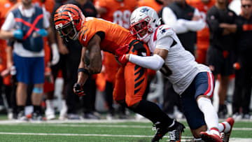 Cincinnati Bengals wide receiver Ja'Marr Chase (1) is tackled by New England Patriots corner back Christian Gonzalez (0) in the second quarter of the NFL game at Paycor Stadium in Cincinnati on Sunday, Sept. 8, 2024.