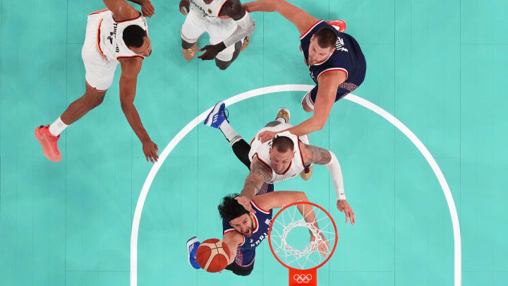 Aug 10, 2024; Paris, France; Serbia point guard Vasilije Micic (22) shoots the ball against Germany power forward Daniel Theis (10) in the men's basketball bronze medal game during the Paris 2024 Olympic Summer Games at Accor Arena. 