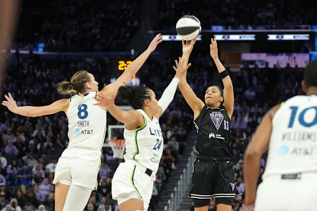 Golden State Valkyries forward Janelle Salaun shoots against Minnesota Lynx forwards Alanna Smith and Napheesa Collier.