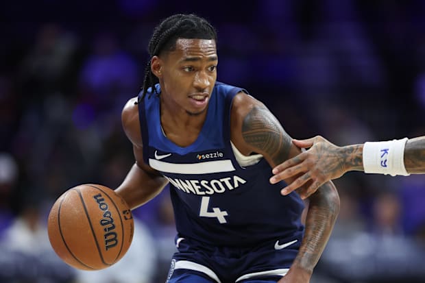 Timberwolves guard Rob Dillingham dribbles the ball against the 76ers.