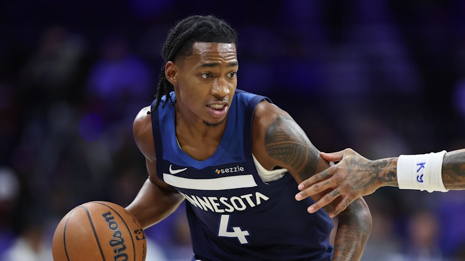 Timberwolves guard Rob Dillingham dribbles the ball against the 76ers.