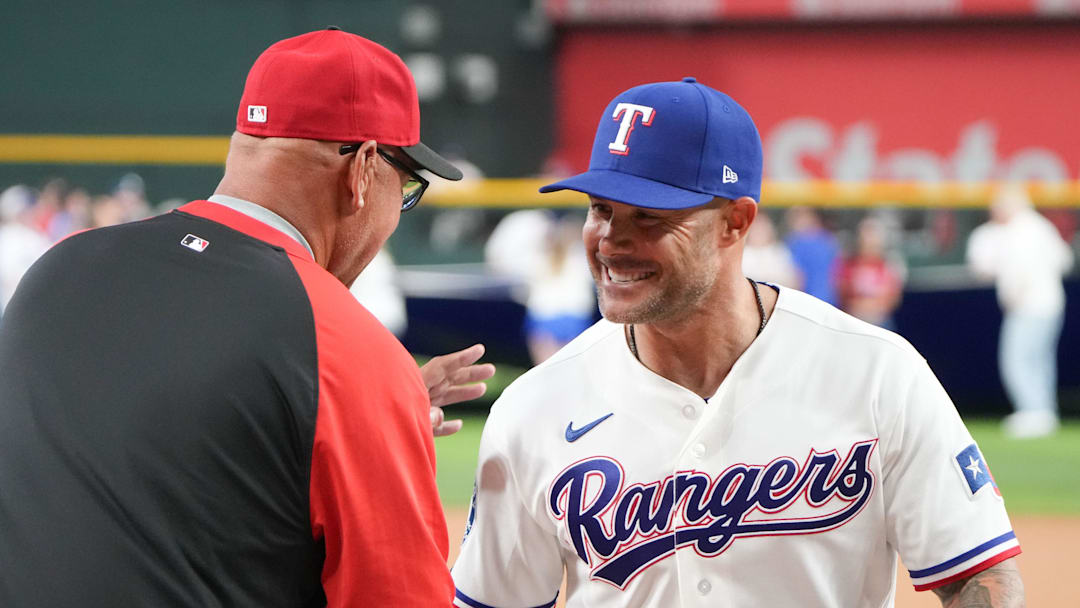 Texas Rangers manager Skip Schumaker greets Cincinnati Reds manager Terry Francona