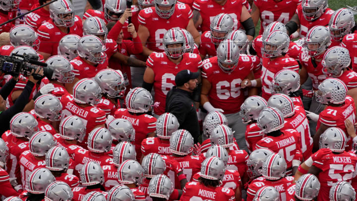 Ohio State coach Ryan Day huddles with his players before facing Maryland.