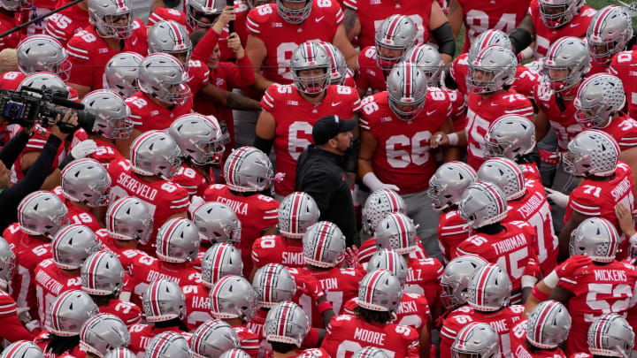 Ohio State coach Ryan Day huddles with his players last season.