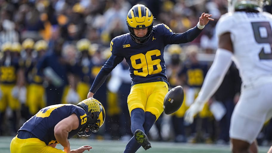 Michigan place kicker Dominic Zvada (96) attempts an extra point during a game against Oregon.