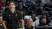 Nov 26, 2025; Cincinnati, Ohio, USA;  Cincinnati Bearcats head coach Wes Miller reacts from the sideline in the game against the Eastern Michigan Eagles in the first half at Fifth Third Arena. Mandatory Credit: Aaron Doster-Imagn Images