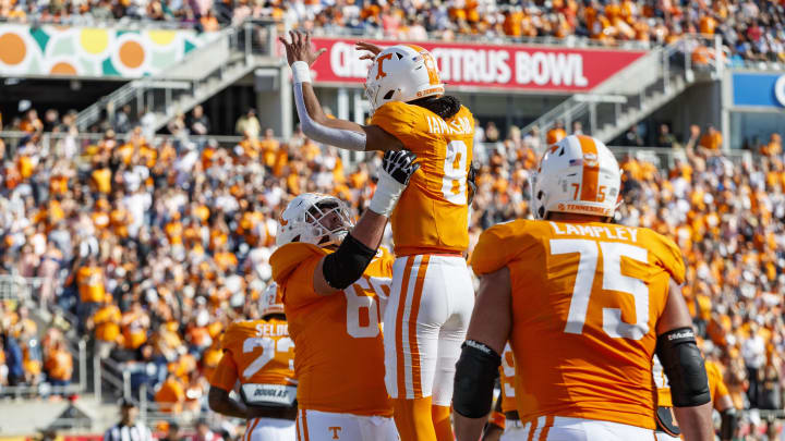 Jan 1, 2024; Orlando, FL, USA; Tennessee Volunteers quarterback Nico Iamaleava (8) and offensive lineman Masai Reddick (68) celebrate a touchdown against the Iowa Hawkeyes during the second quarter at Camping World Stadium. Mandatory Credit: Morgan Tencza-USA TODAY Sports